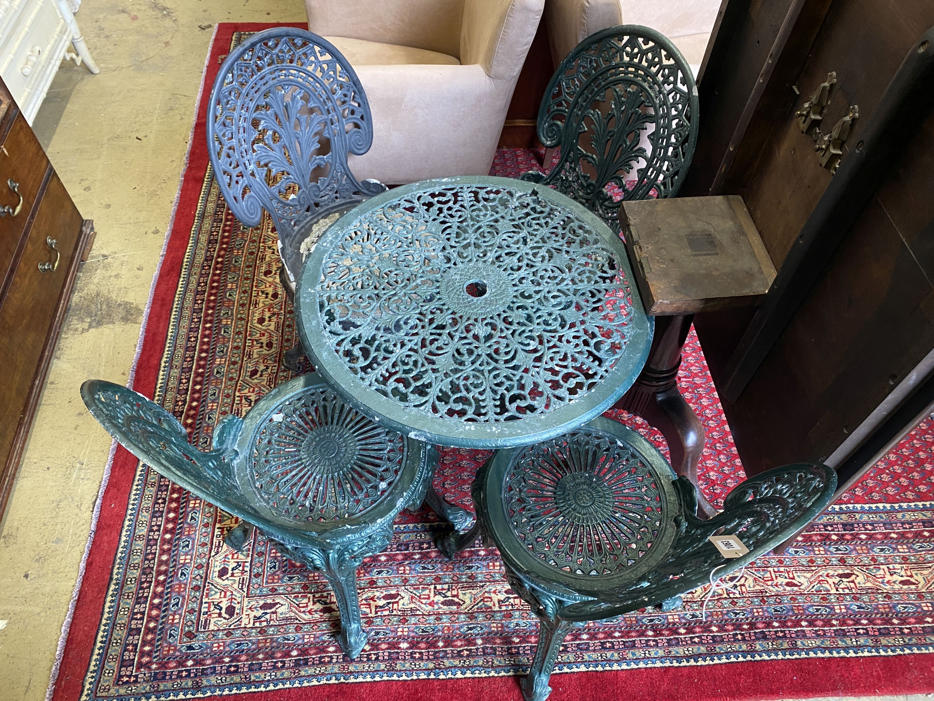 A Victorian style circular painted aluminium garden table, diameter 66cm, height 66cm and four chairs